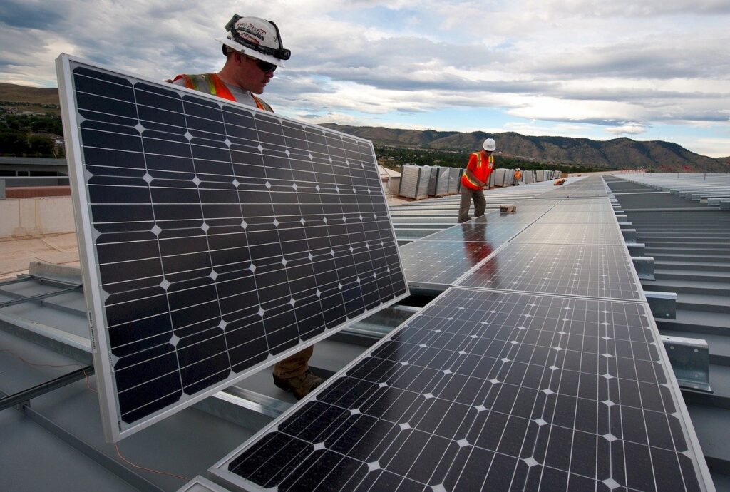 Construction workers assembling and array of solar panels